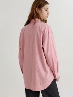 Back view of the pink bow-tie front collared shirt, showing its silhouette and design details.