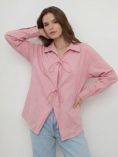 Full-length front view of the pink bow-tie front collared shirt, showing its silhouette and design details.