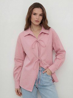 Lifestyle front view of the pink bow-tie front collared shirt, showing its silhouette and design details.