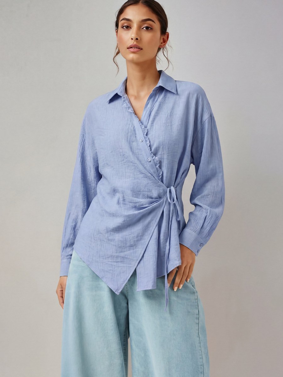 Blue Collared Side-Tie Wrap Shirt – Front View Front view of the blue collared side-tie wrap shirt, showing its silhouette and design details.