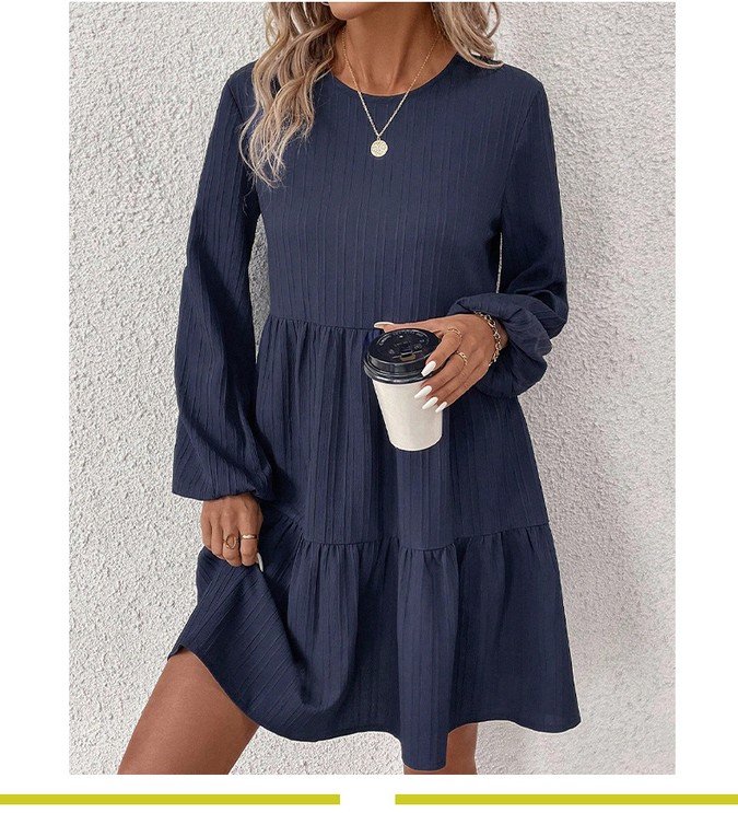 Front view of the navy long-sleeve tiered smock dress, showing its silhouette and design details.