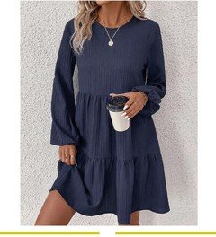 Front view of the navy long-sleeve tiered smock dress, showing its silhouette and design details.
