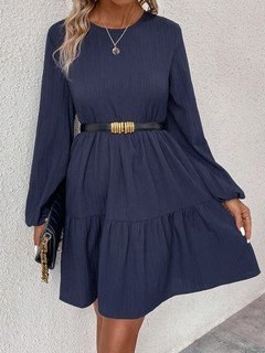 Styled front view of the navy long-sleeve tiered smock dress, showing its silhouette and design details.