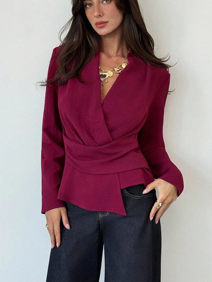 Front view of the burgundy draped long-sleeve wrap blouse, showing its silhouette and design details.