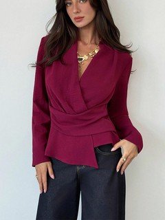 Front view of the burgundy draped long-sleeve wrap blouse, showing its silhouette and design details.