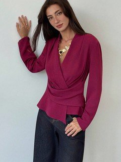 Full-length front view of the burgundy draped long-sleeve wrap blouse, showing its silhouette and design details.