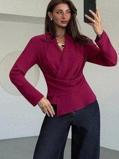 Lifestyle front view of the burgundy draped long-sleeve wrap blouse, showing its silhouette and design details.