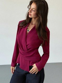 Styled front view of the burgundy draped long-sleeve wrap blouse, showing its silhouette and design details.