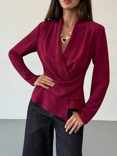 Three-quarter front view of the burgundy draped long-sleeve wrap blouse, showing its silhouette and design details.