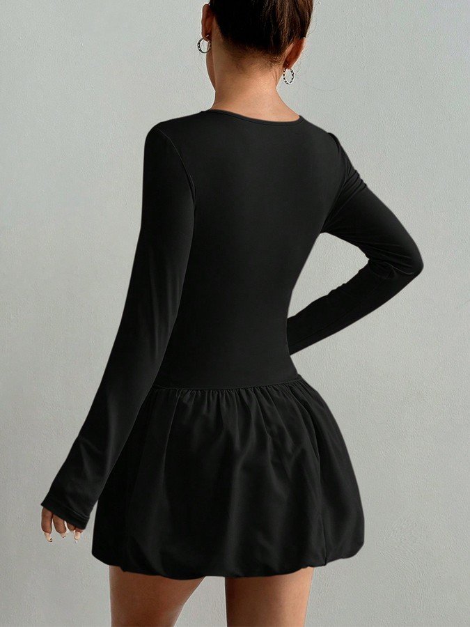 Back view of the black long-sleeve bubble hem dress, showing its silhouette and design details.