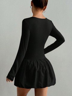 Back view of the black long-sleeve bubble hem dress, showing its silhouette and design details.