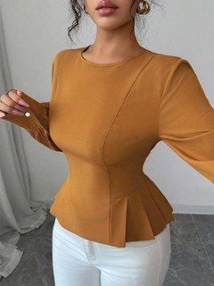 Close-up of the ochre tailored long-sleeve peplum blouse, showing its silhouette and design details.