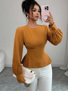Styled front view of the ochre tailored long-sleeve peplum blouse, showing its silhouette and design details.