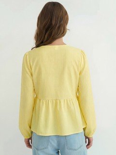 Back view of the yellow tie-front long-sleeve blouse, showing its silhouette and design details.