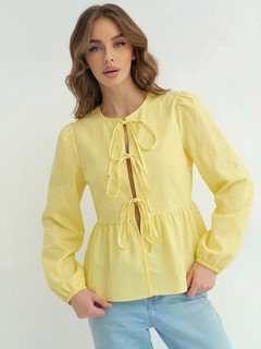 Front view of the yellow tie-front long-sleeve blouse, showing its silhouette and design details.