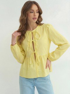 Full-length front view of the yellow tie-front long-sleeve blouse, showing its silhouette and design details.