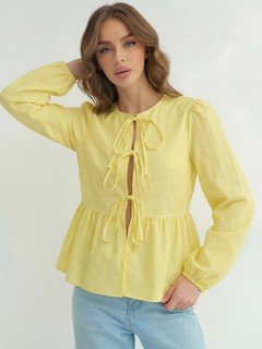 Three-quarter front view of the yellow tie-front long-sleeve blouse, showing its silhouette and design details.
