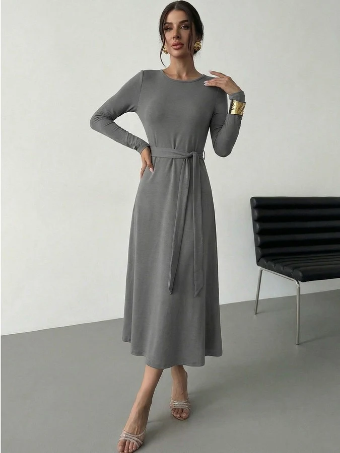 Angled front view of the gray tie-waist long-sleeve midi dress, showing its silhouette and design details.