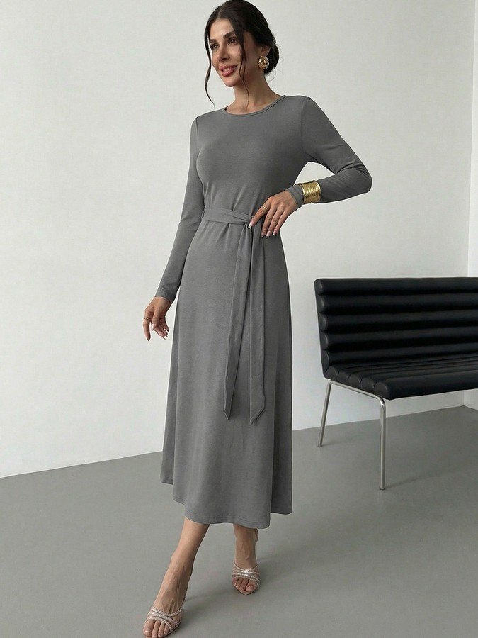 Front view of the gray tie-waist long-sleeve midi dress, showing its silhouette and design details.