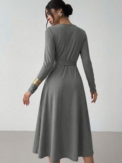 Back view of the gray tie-waist long-sleeve midi dress, showing its silhouette and design details.