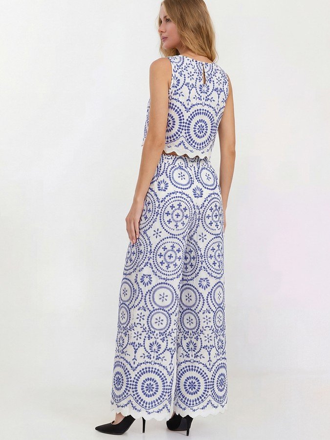 Back view of the blue and white medallion print top and pants set, showing its silhouette and design details.