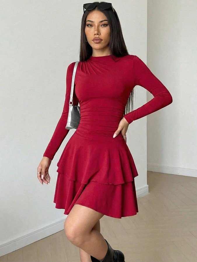 Angled front view of the red long-sleeve tiered ruffle dress, showing its silhouette and design details.