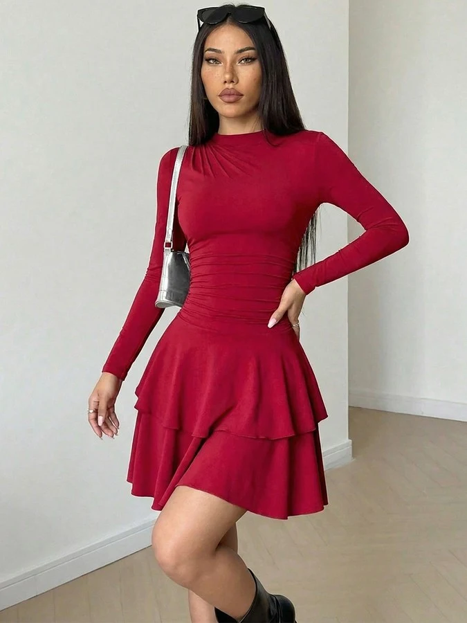Angled front view of the red long-sleeve tiered ruffle dress, showing its silhouette and design details.