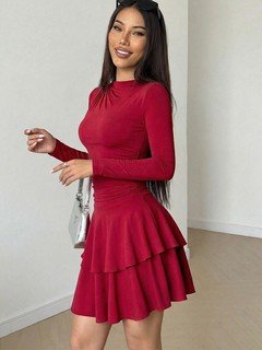 Full-length front view of the red long-sleeve tiered ruffle dress, showing its silhouette and design details.