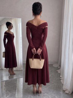 Back view of the burgundy off-shoulder pleated a-line midi dress, showing the silhouette and fit.