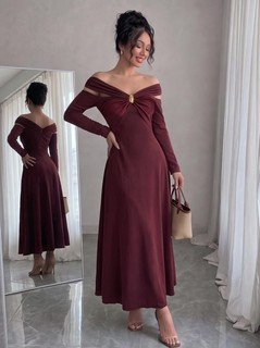 Model angled view of the burgundy off-shoulder pleated a-line midi dress, showing the silhouette and fit.