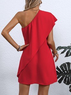 Back view of the red one-shoulder overlay mini dress, showing its silhouette and design details.