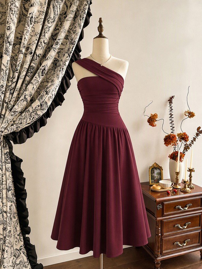 Mannequin front view of the burgundy one-shoulder pleated a-line midi dress, showing the silhouette and fit.