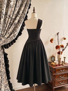 Mannequin front view of the black one-shoulder pleated a-line midi dress, showing the silhouette and fit.