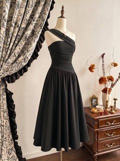 Mannequin front view of the black one-shoulder pleated a-line midi dress, showing the silhouette and fit.