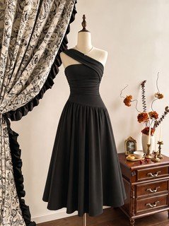 Mannequin front view of the black one-shoulder pleated a-line midi dress, showing the silhouette and fit.