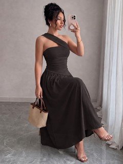 Model angled view of the black one-shoulder pleated a-line midi dress, showing the silhouette and fit.