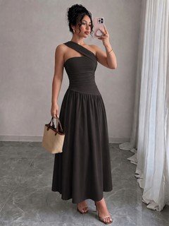 Model angled view of the black one-shoulder pleated a-line midi dress, showing the silhouette and fit.