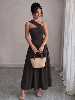Model side view of the black one-shoulder pleated a-line midi dress, showing the silhouette and fit.