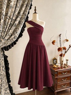 Mannequin front view of the burgundy one-shoulder pleated a-line midi dress, showing the silhouette and fit.