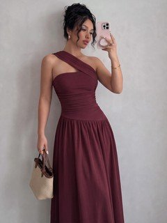 Model angled view of the burgundy one-shoulder pleated a-line midi dress, showing the silhouette and fit.