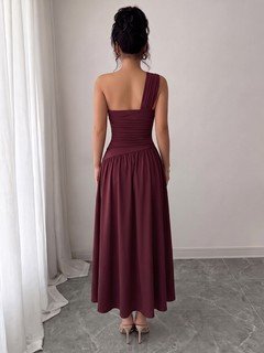 Model back view of the burgundy one-shoulder pleated a-line midi dress, showing the silhouette and fit.