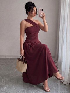 Model side view of the burgundy one-shoulder pleated a-line midi dress, showing the silhouette and fit.