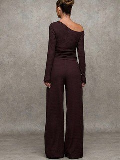 Back view of the brown one-shoulder top and pants set, showing its silhouette and design details.