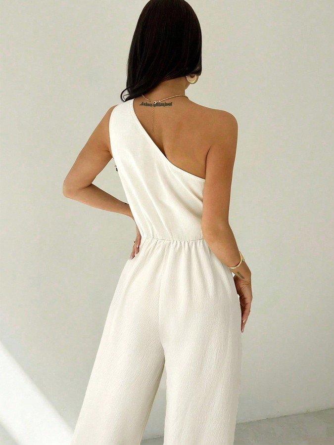 Back view of the ivory one-shoulder tie-waist wide-leg jumpsuit, showing the silhouette and fit.