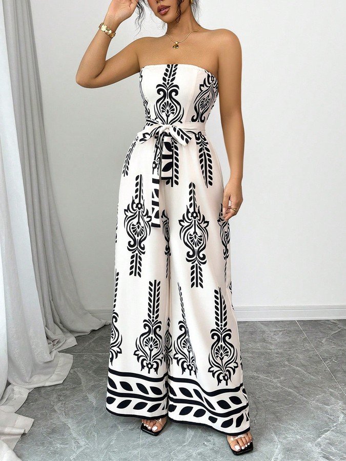 Angled front view of the white and black ornamental strapless jumpsuit, showing its silhouette and design details.