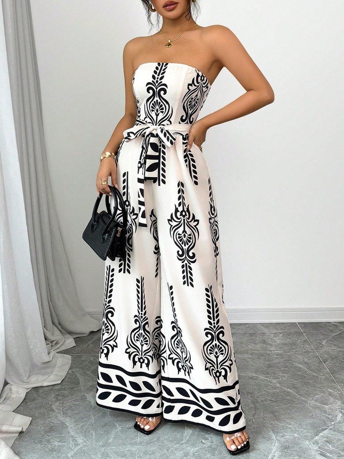 Front view of the white and black ornamental strapless jumpsuit, showing its silhouette and design details.