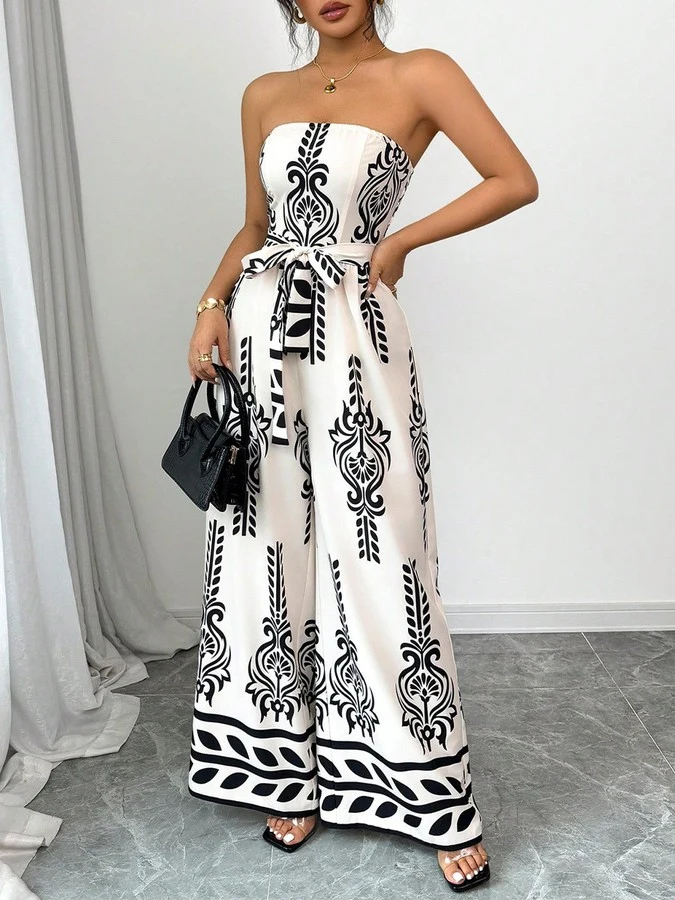 Front view of the white and black ornamental strapless jumpsuit, showing its silhouette and design details.