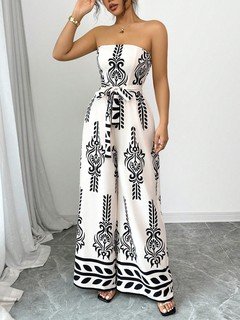 Angled front view of the white and black ornamental strapless jumpsuit, showing its silhouette and design details.