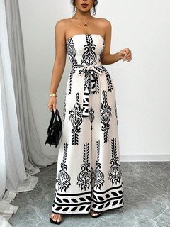Full-length front view of the white and black ornamental strapless jumpsuit, showing its silhouette and design details.