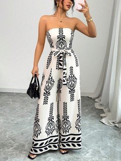 Lifestyle front view of the white and black ornamental strapless jumpsuit, showing its silhouette and design details.